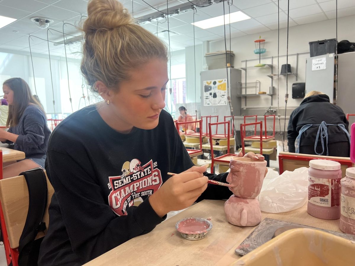 Prezley Martin paints her ceramics project with glaze. Ceramics 1 classes have started working to glaze their first project the past two days. “My favorite part of ceramics so far is our first project," Martin said. "We got to build and create whatever we wanted. Ceramics is challenging because it’s my first time doing it. I’m not used to it yet and there’s a lot of technique and skill involved.”