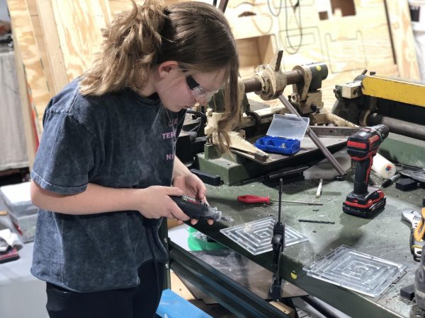 Sophomore Kaylee Holverson works on a poly-carbonate plate during a robotics meeting. Holverson also helps mentor elementary school children with robotics as well.