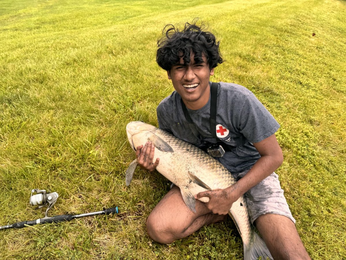 Senior Mahindra Mandala poses with the grass carp he caught on June 1, 2024.