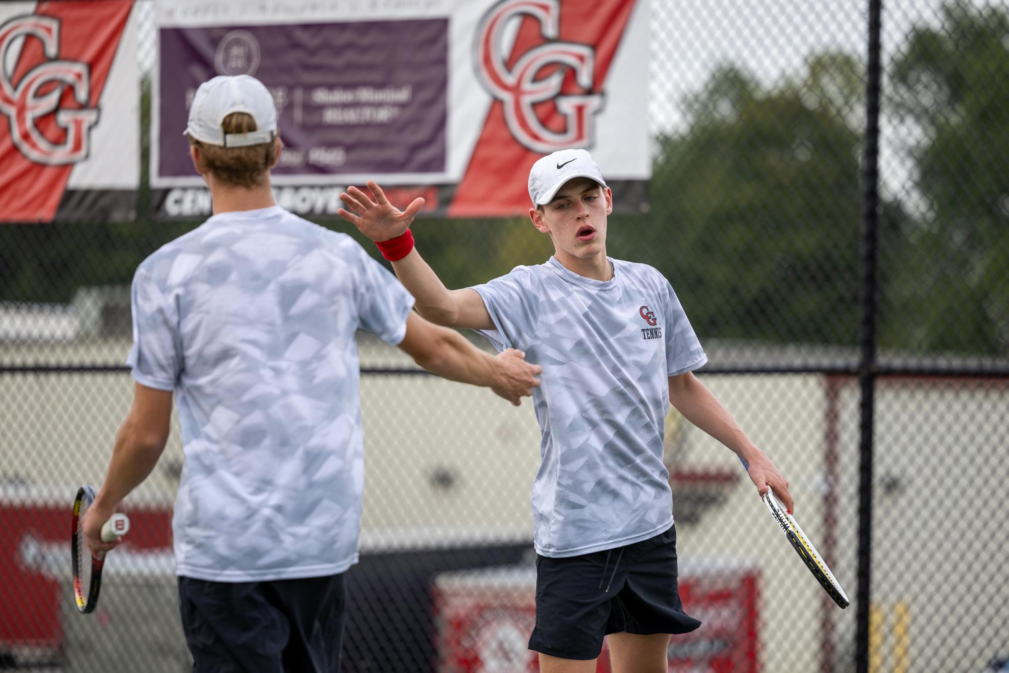 Junior Jack Dybwad and senior Russell Dean celebrate a point in their sectional matchup against Greenwood.