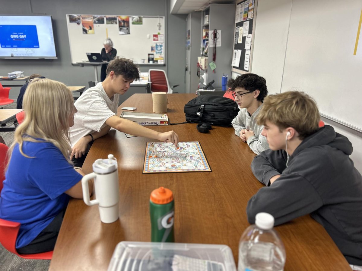 Sophomore Kenzie Lessor, Zavier Laney, Parker Kwoczaka and Blayne Kibett play Chutes and Ladders during STaR. STaR is homeroom-type class that meets on Mondays and Fridays. "This game helps me connect with my peers that I will be with for the next four years," Laney said.