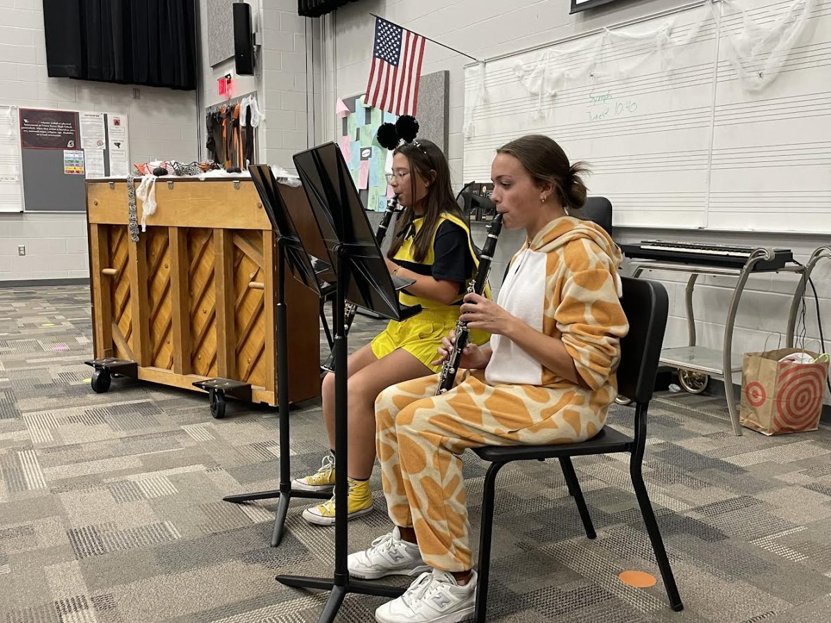 During Tri-M’s annual Halloween event, senior Sophia Smith and freshman Margaret Walker preform a piece on their clarinets for the club Smith enjoyed playing for others, and encouraged others to join the club because of all the opportunities it offers. “I think it’s a great way to begin performing in public as everyone has the same interests and are easy to relate to on an experience standpoint,” Smith said. “We have a great time with each other and its a much different environment than a regular National Honors Society.”  