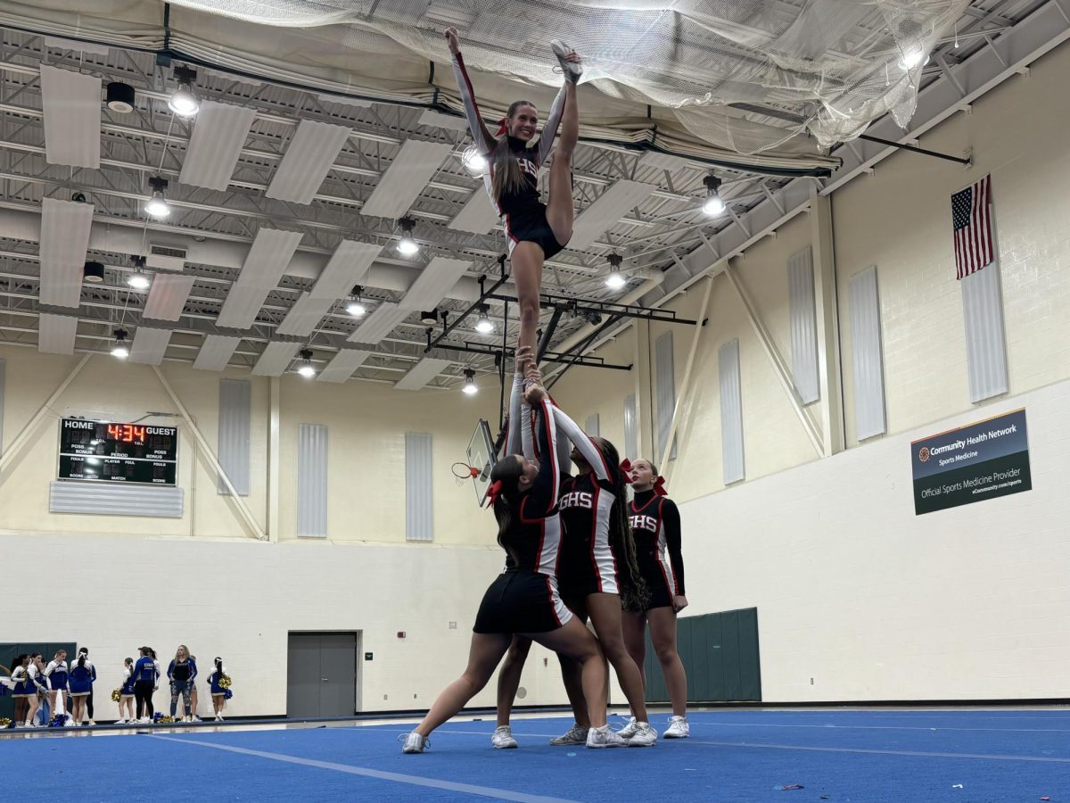 The Comp Team cheerleaders perform a stunt while competing at Pendleton High School. The team won for their Traditional routine and placed fourth for their Gameday routine. “I love competing with the Center Grove competition team because it’s an embracing environment,” junior Selia Peters said. “Although the practices are tough, the feeling of competing is totally worth it.”