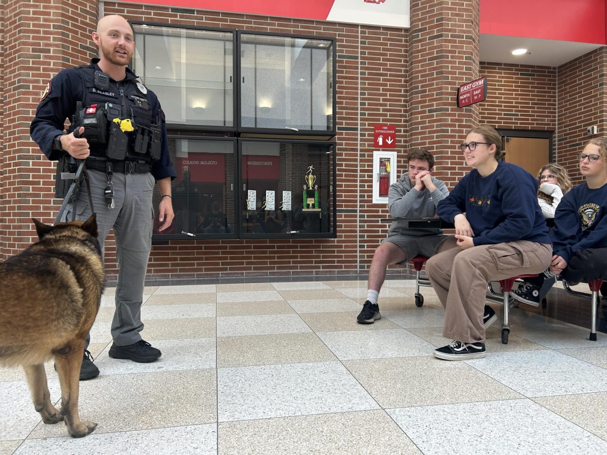 Students from Mr Timmons AP Psychology class watch a demonstration of how a police dog and their handler can detect drugs, bombs, firearms, and other various items to ensure the schools safety from resource officer Dave Beasley. The students are currently studying how the brain detects, perceives and makes sense of our surroundings in our everyday lives. “I liked the demonstration since it was a fun way to learn how we can use our senses,” junior Ethan Zheng said.