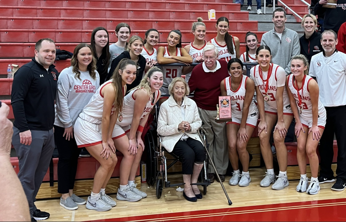 Members of the girls basketball team pose with former Assistant Athletic Director Carol Tumey following their 62-45 win over Brownsburg in the second annual Carol Tumey Holiday Tournament. 