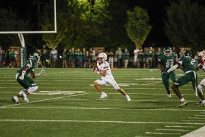 Sophomore Drake McClurg runs after the catch in a 24-10 victory against the Trinity Shamrocks. McClurg scored two touchdowns and broke the school single-game receiving yardage record with 238 yards during the game.