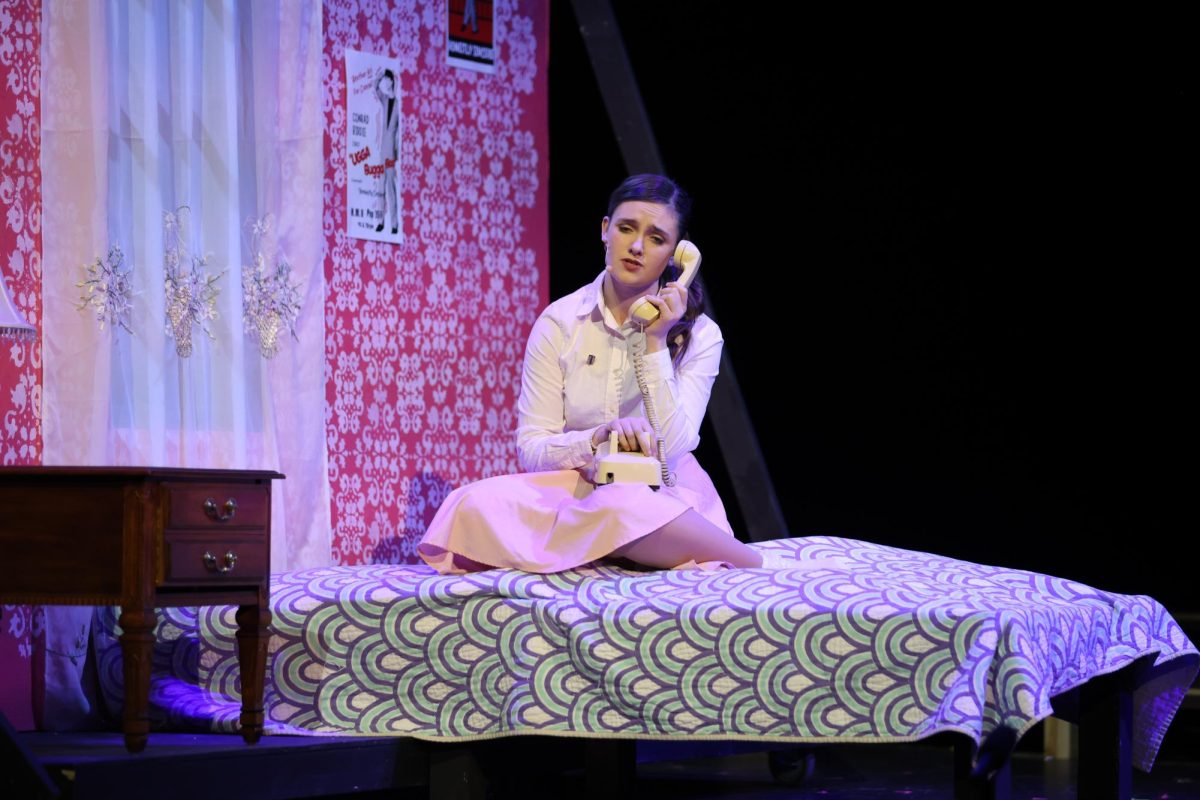 Junior Claire Lollar listens on the phone during "Bye Bye Birdie". Claire plays the role of Kim McAffee in the musical. "I love theater," Lollar said. "It's just a different way to express yourself compared to other forms of art. It's just a fun way to push yourself outside of your comfort zone. The different shows each year have a different dynamic especially figuring out the show, the sets, all the transitions and the costuming. It's also a different bond. Last year, it was like a family and this year it's even more of a family. Even though it's still a lot of people, we all have gotten so close over the past few months."