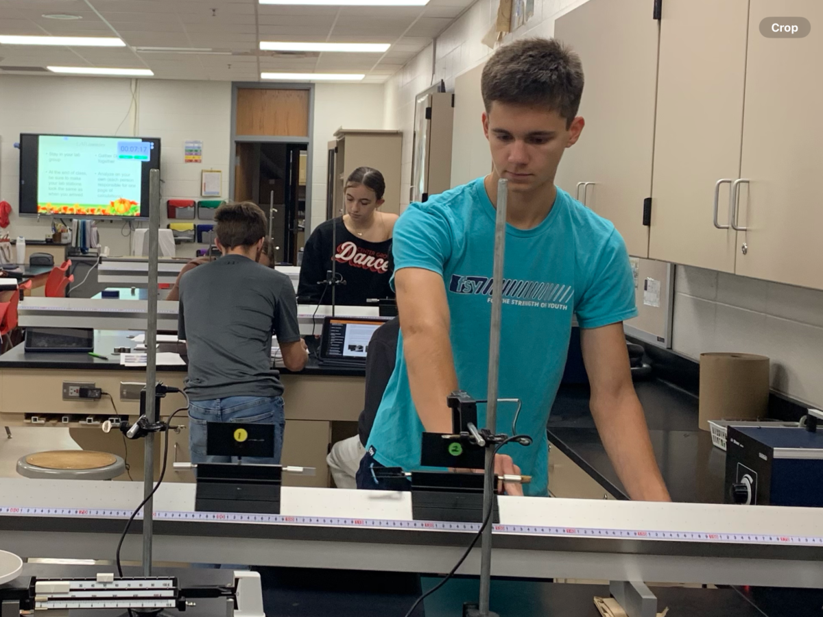 Junior Jeffery Sweeney watches as two gliders collide in a lab in his physics class. The lab was supposed to demonstrate to students the law of conservation of momentum and the difference between elastic and inelastic collisions. “My favorite part of the lab was setting up the head on collisions between the gliders,” Sweeney said. “I liked watching them either stick together or bounce off of each other, depending on whether the collision was elastic or inelastic.”