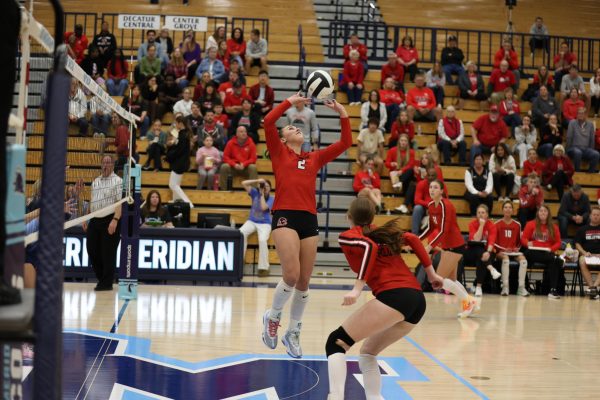 Sophomore Anabelle Schembra sets the ball for sophomore Kaelyn Groce during the Trojans' sectional semi-final win against Perry Meridian.