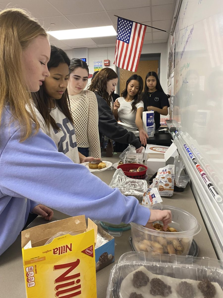 Sophomore Ava Sanders participates in a cultural potluck in her AP Human Geography class. Sanders contributed a German snack that is family favorite. “I prepared a snack that was a favorite of my family that still lives in Germany," Sanders said. "I was able to connect with them by making this. I was really able to see how many different heritage and ethnic groups are in the school and just in our class."