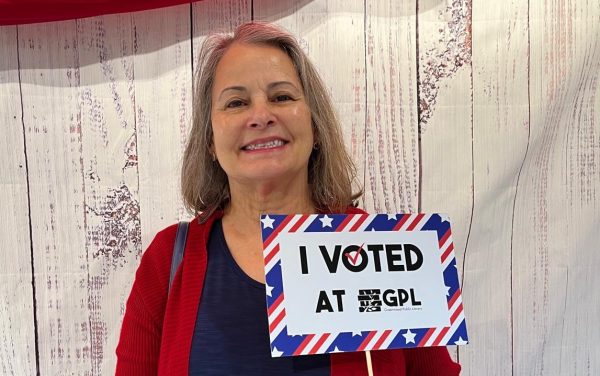 Maria Lucia Godoy poses with a voting sign after casting her ballot.