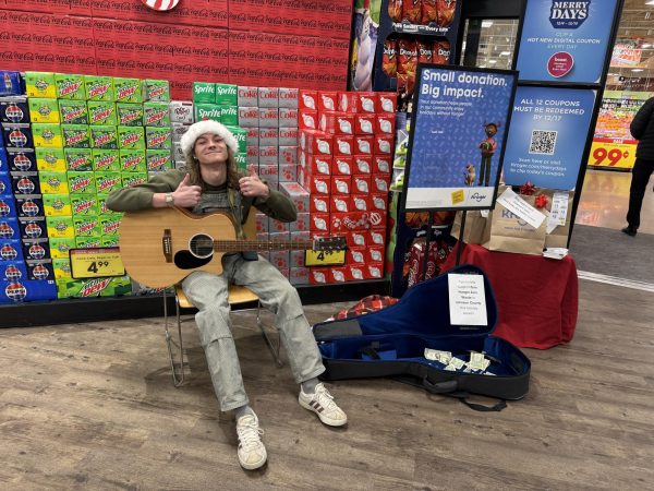 Sophomore Jayden Winkle raises money for food banks by setting up donations at Kroger on 135. He played Christmas music and other songs to bring entertainment to the entrance.  “When I started working here I came up with the idea to play music to raise money for the food banks. Kroger does this every year around Christmas and I thought playing guitar would be a good idea,” Winkle said. 