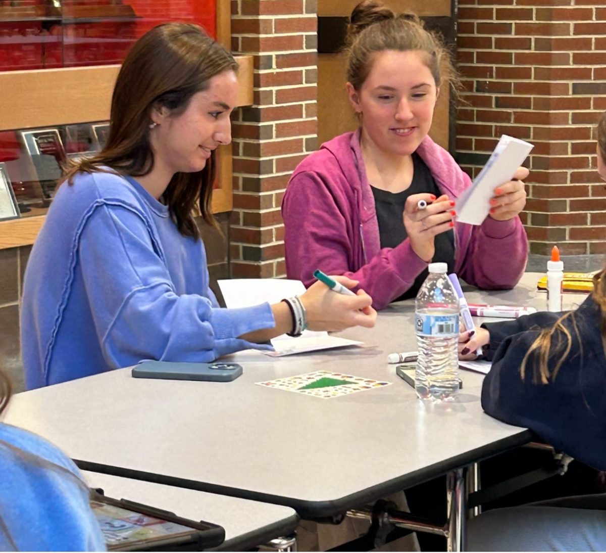 During STaR on Monday, Elise Miller and senior Katie Lakes, make christmas cards during a Best Buddies meeting. “I like hanging out with regular kids that do and don’t have disabilities.” Miller said. 