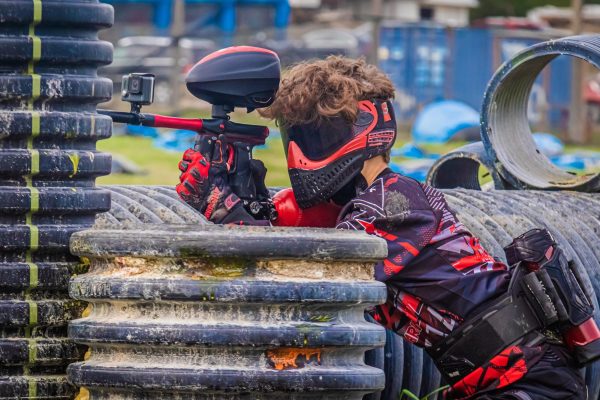 Sophomore Maddox May uses a paintball gun during a game.