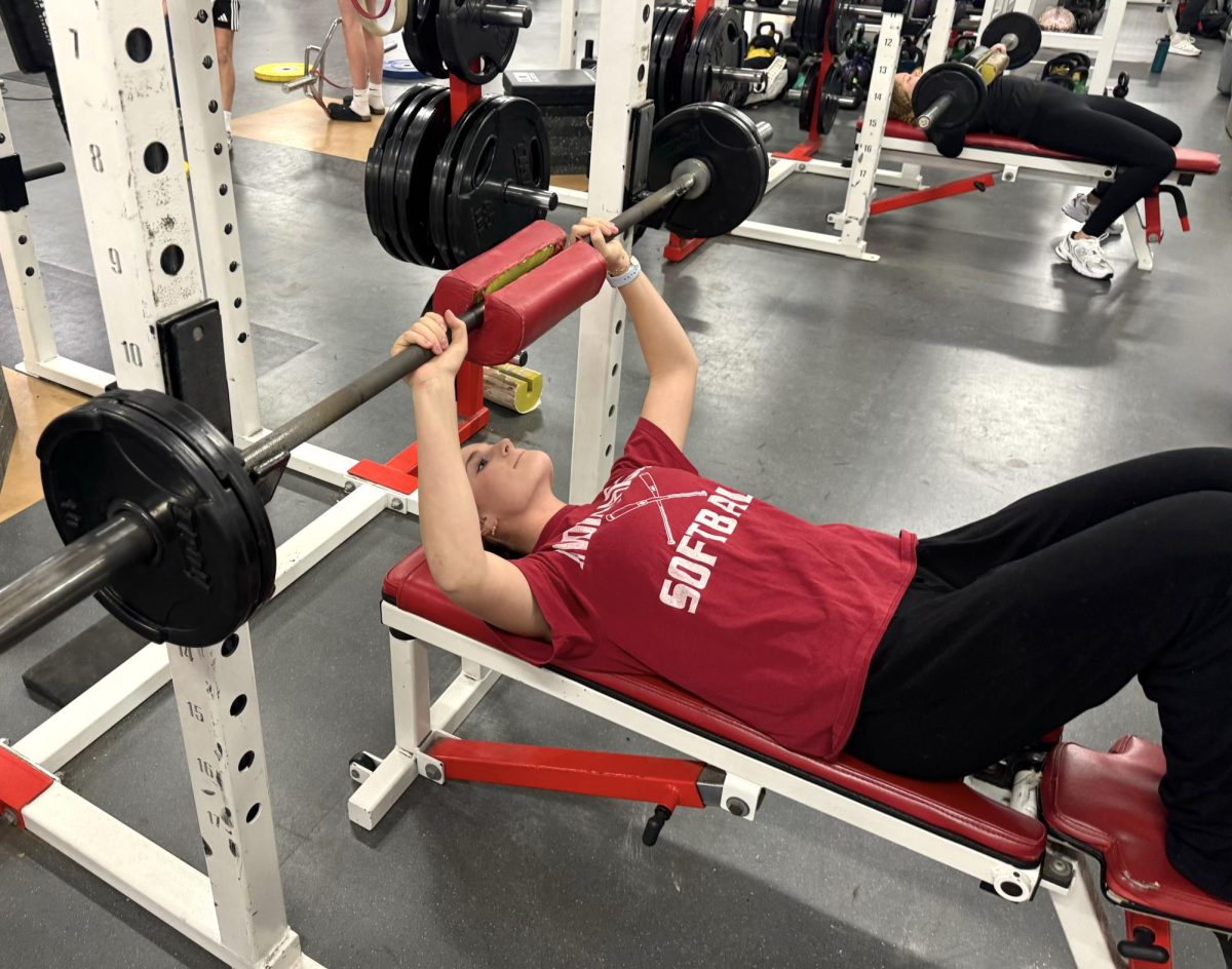 Sophomore Avery Bastien attempts a bench press in 10th period Weights. The second semester typically brings on new training partners as student schedules shift, creating a different environment in each class. “I like weights because I like being able to get better at my sport with weight training,” says Bastien. “Having training partners helps because it pushes me to be better by adding some competition.” 