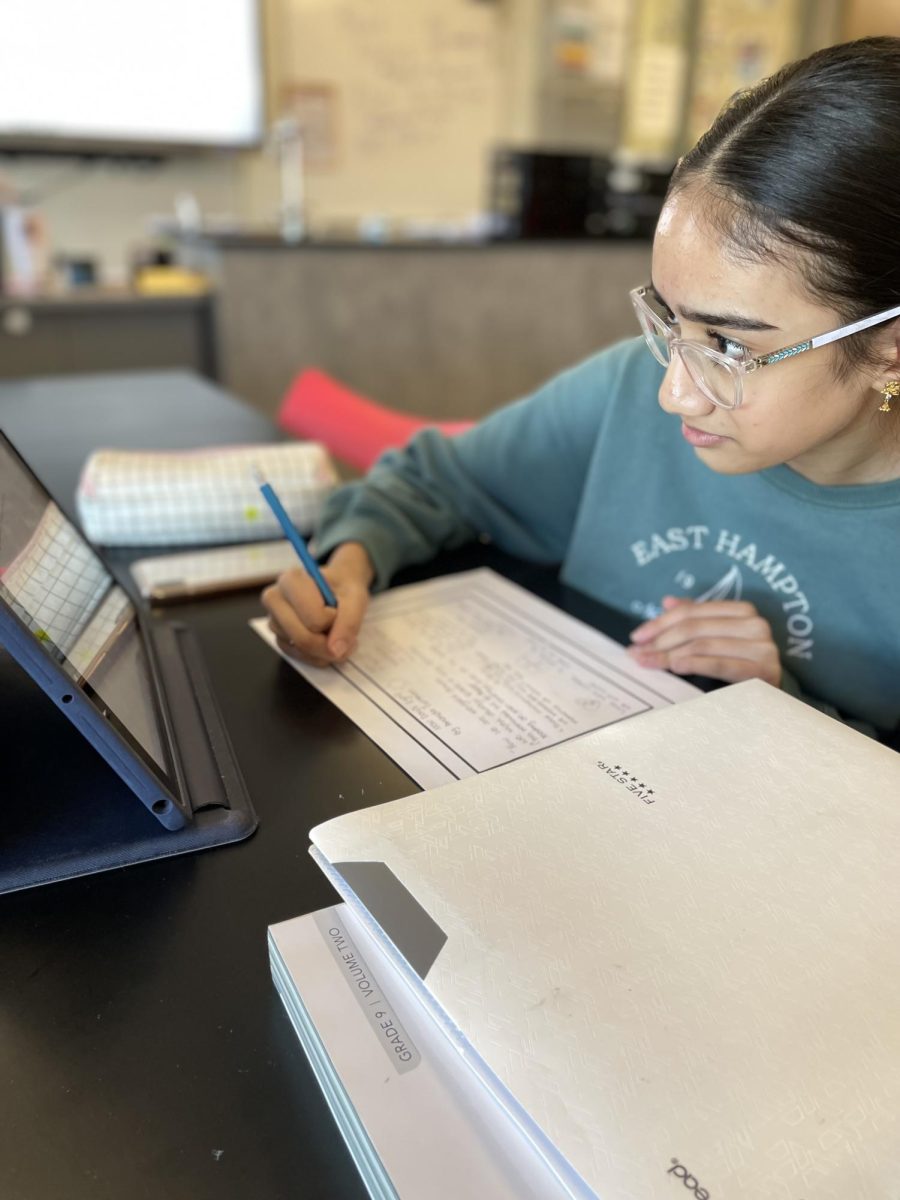 Freshman Pranathi Kandhallu Saravanakumar works on homework for the start of a new unit in her Biomed class the first day back from Winter Bread and an unexpected snow day. The school got an extra day of break due to a large snow storm which caused road closure. “I enjoyed break because it gave me time to recollect and refresh my mind,” Saravanakumar said. “I was really happy to find out about the snow day. I’m excited to have a fresh start and do well this semester.” 