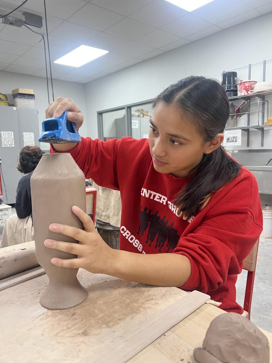 Working on her ceramics project, senior Izzy Ferguson shaves down her vase to make it more level. The ceramics 1 classes worked all week to create and make a vase to their liking. “My favorite part of this project was smoothing it out,” Ferguson said, “I used the shaver to level it out and get rid of all of the bumps”. 