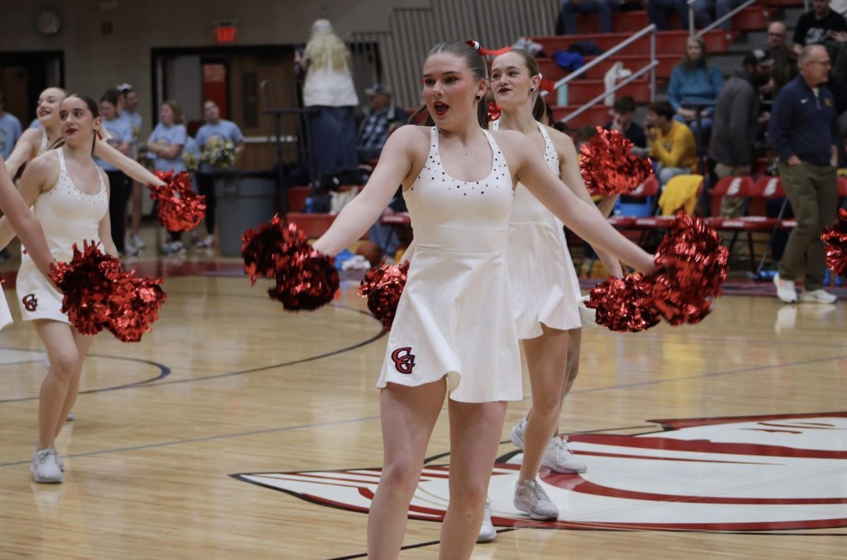 "Showing On

Senior Sarah Hendrix performs in front of a crowd during halftime at a Boys Varsity Basketball game vs. Mooresville on Feburary 18, as part of a ancestral team routine. The dance team performed as part of a two-event halftime show that night, immediately before the Best Buddies basketball game.

“It feels a little nerve-wracking, but you also know that everyone there is a CG fan,” Hendrix said. “It’s also just fun getting to perform for others because they don’t really get to see our competition dances.”"