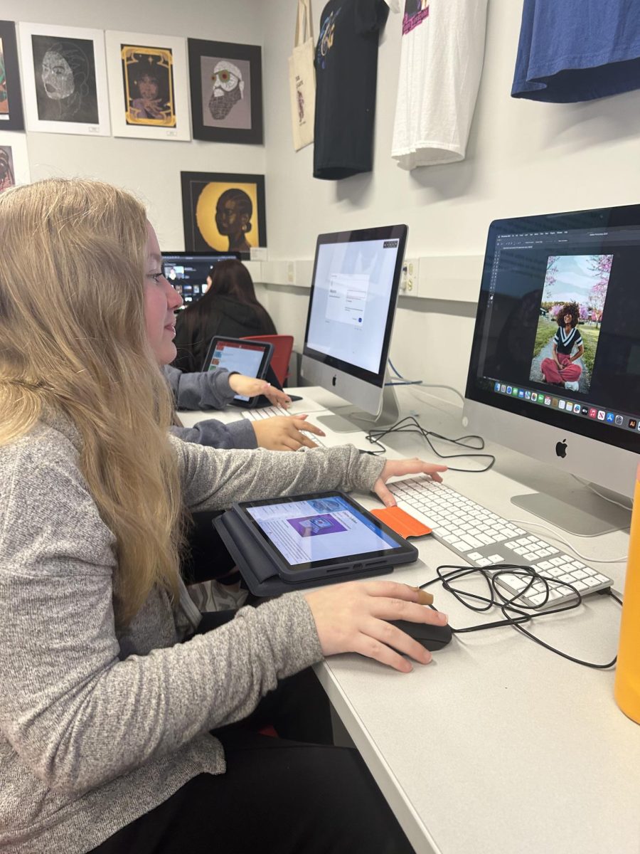 Junior Livia Cameron works on her latest Visual Communications practice assignment in photoshop. Students in Visual Communications watched videos and practiced with the software all of this week to get ready for their first big project with the new software. “We are learning how to take photos and make them our own,” Cameron said. “Like how to add things to pictures, and take away things we don’t want on pictures.”