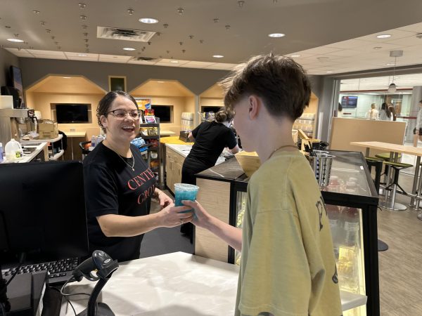 "
Elaina Cisneros hands a student a vibrant blue drink she just prepared. Throughout the day, she’s been busy crafting beverages and keeping the café running smoothly. “Seeing students enjoy what I make is the best part of my job,” Cisneros said."