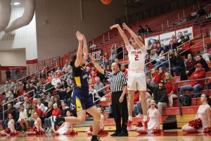 Sophomore Zavier Laney shoots beyond the arc in the Trojans' last matchup against Mooresville, which occurred in the regular season. The Trojans lost that game, 69-73.