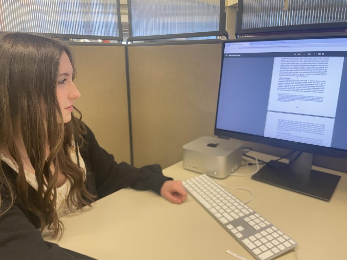 Sophomore Nora Liden looks for research articles on a computer. Honors English 10 students went to the IU Indy library on Tuesday, and collected information about their authors for their modern author project. “I thought going to the college’s library was fun,” Liden said. “Getting to find more reliable research with my group was a good experience to have.”