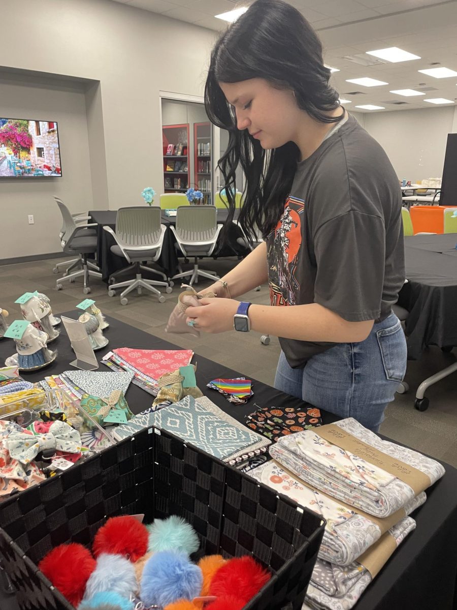Junior Norin Kelly shops through the C3 store. The store sold cookies, stuffed animals, soap, CG apparel, and much more. “I like the C3 store because it’s a whole collection of fun goodies,” Kelly said, "It's fun to take a break from learning during the day and go talk to my friends and shop around.” 
