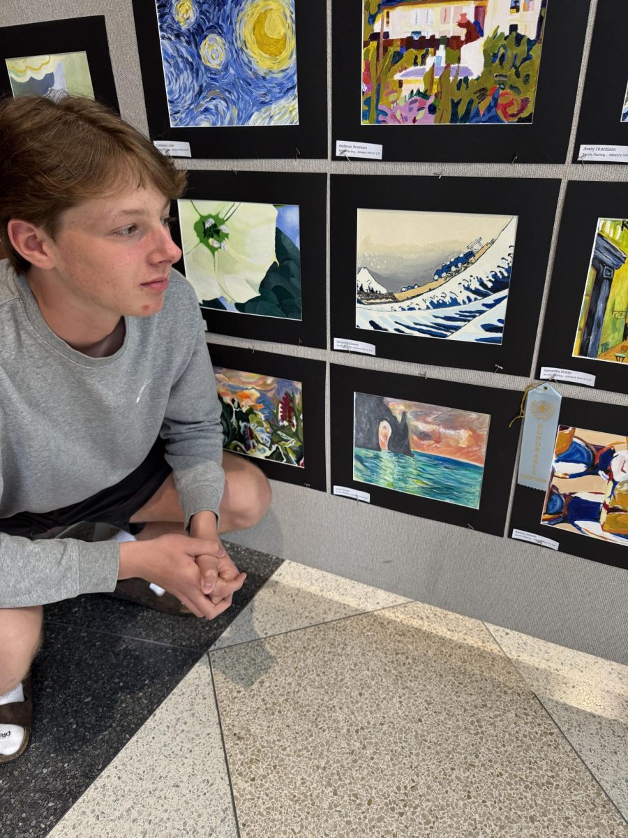 Sophomore Benjamin Klassen views his classmates and his artwork that was entered in the Center Grove art show. There was a huge selection of diverse works of art that were selected for the show located in the Hall of Excellence. “Mrs. Shackleford told us one of the best ways to learn and appreciate the art of famous artists is to copy or recreate a work of their art,” Klassen said. “For our assignment we chose an image from a list of artists' work. Then we repainted it as accurately as possible. My favorite thing about the class is the variety of things we do.”