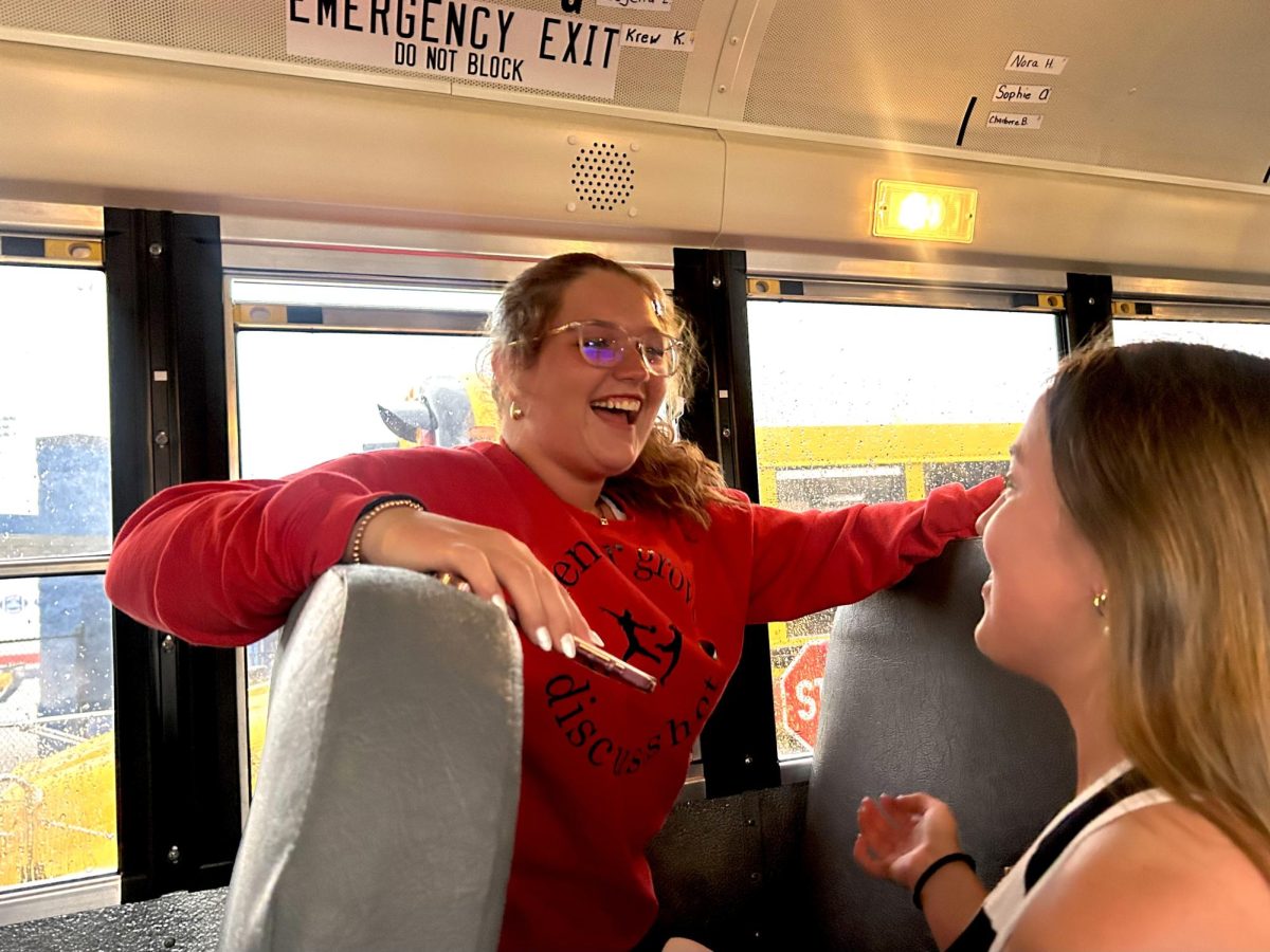 Sophomore Emily Allen talks with Senior Baylee Dominy on the bus while waiting in the parking lot of Whiteland Community High School during a rain delay. “The rain delay was really unfortunate because I was looking forward to throwing,” Allen said. “A lot of our meets have had bad weather and it would’ve been nice to have a meet that was sunny.” Shortly after the rain delay, the track meet was cancelled due to thunderstorms. 