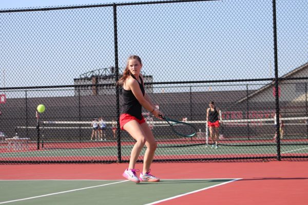 Senior Ashley Embrey sets up to return a serve against Perry Meridian.