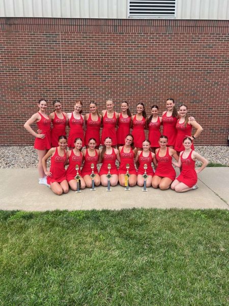 The dance team poses with the trophies they earned over the duration of their stay at the summer camp.