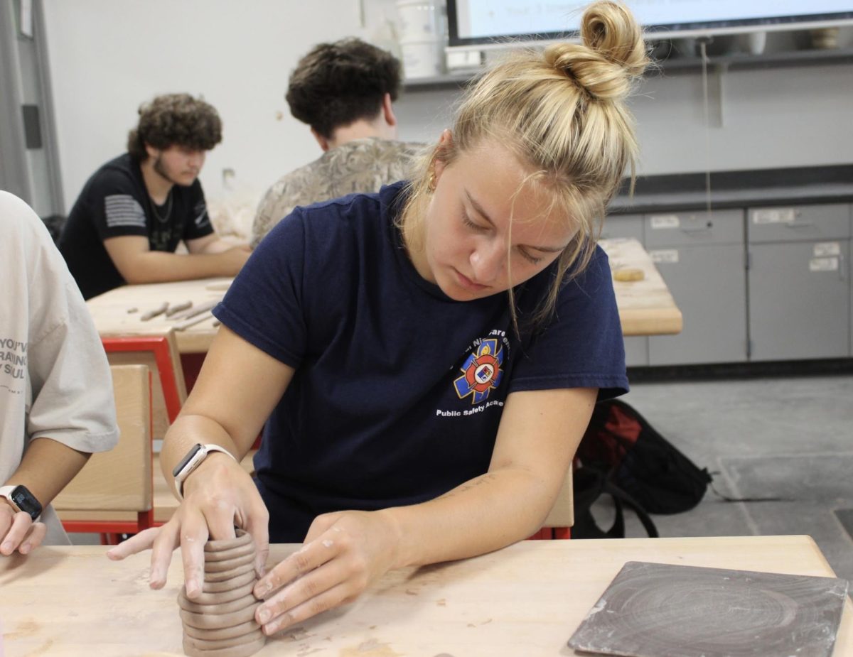 In Mr. Fry’s Ceramics class, senior Mackenzie Nuttle works on her shown coil sculpture pot. Students worked on creating three bases for their sculptures; a pinch pot, a slab with rounded edges, and a rolled up coil that makes a circle. “This was our first big project that we have done,” Nuttle said. “I really enjoyed the challenge of it though because it helped me learn how to piece different structures together.”