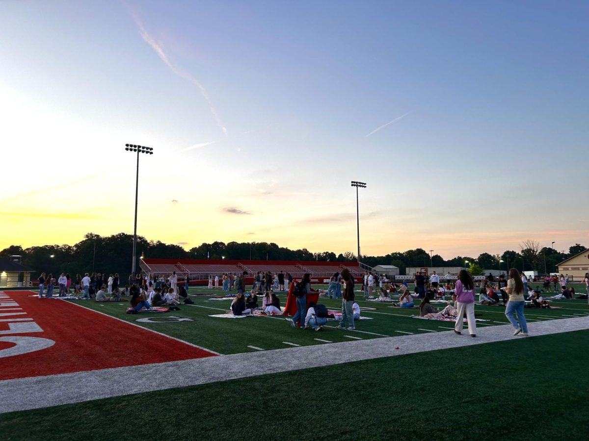 Seniors gather on the field at Ray Skillman Stadium to celebrate Senior Sunrise.