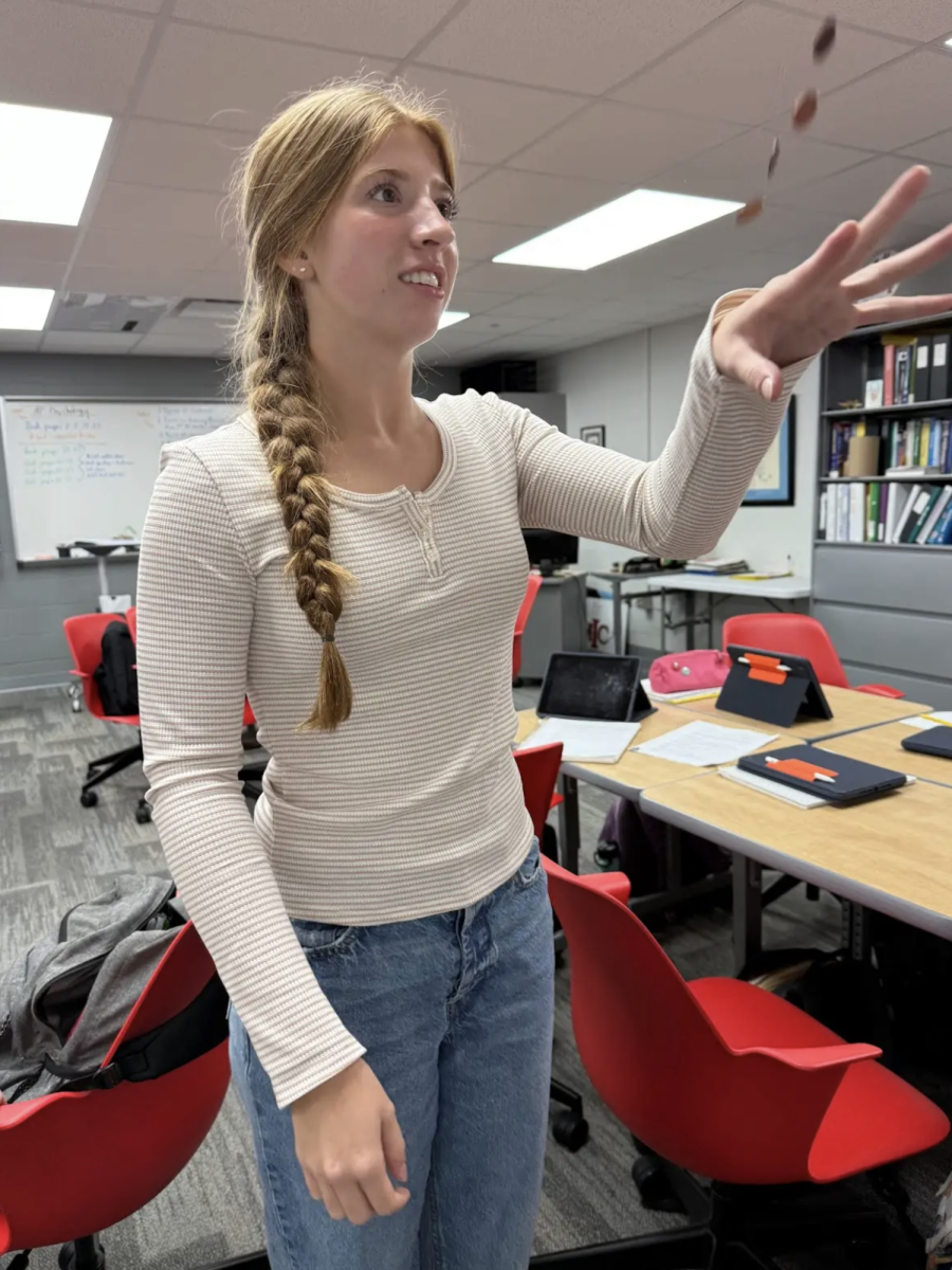 In Brad Timmons’ AP Psychology class, junior Daisy Riley flips a coin with her non dominant hand. Students learned about the bilateral theory by testing how many coins they could catch with both hands, with half of the class starting with their dominant and the other half starting with non dominant. “Doing it with our non dominant first made your dominant hand do way better,” Riley said.