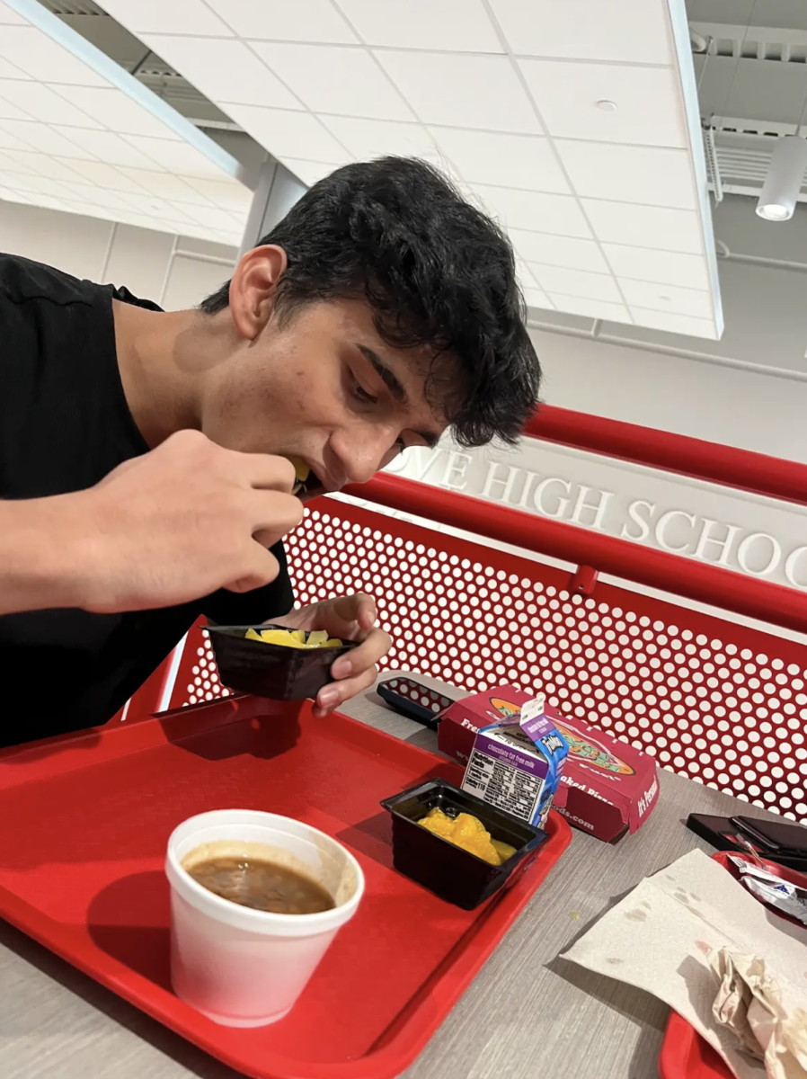 Aryan Nixon ‘27 tries out the new cafeteria’s food for the first time. Due to the surplus of students, Center Grove added a new wing, the academic pavilion, with its own cafeteria. “I really enjoy the atmosphere here,” Aryan says. “There’s a lot of natural light and I really like the food in this cafeteria. I’m going to be eating here from now on.”