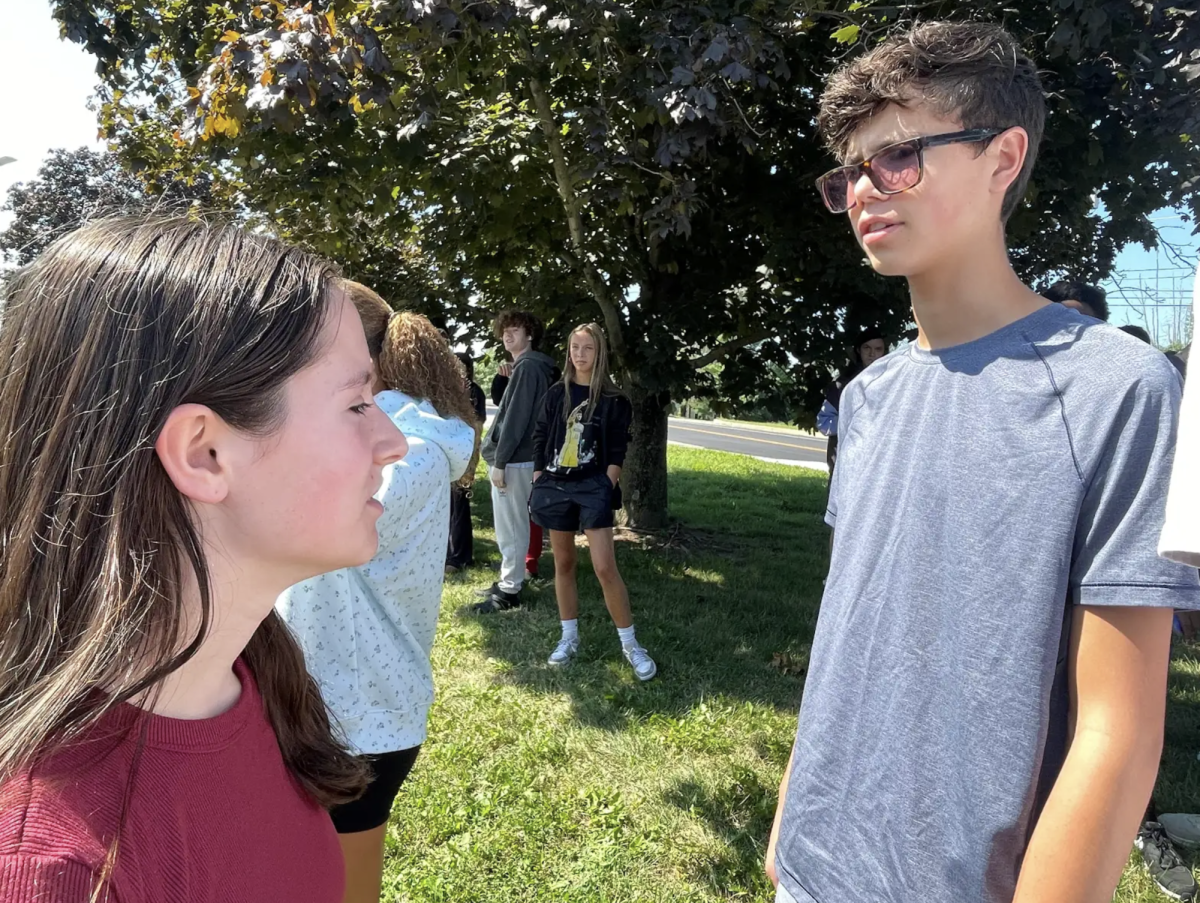 Elijah Wright ('27) talks with Makenzie Wade ('27) in the midst of a fire-drill during star. “I was kind of glad there was a fire drill because all my classes are really cold,” Wade said. “Going outside where it was warm and taking a break was nice.”