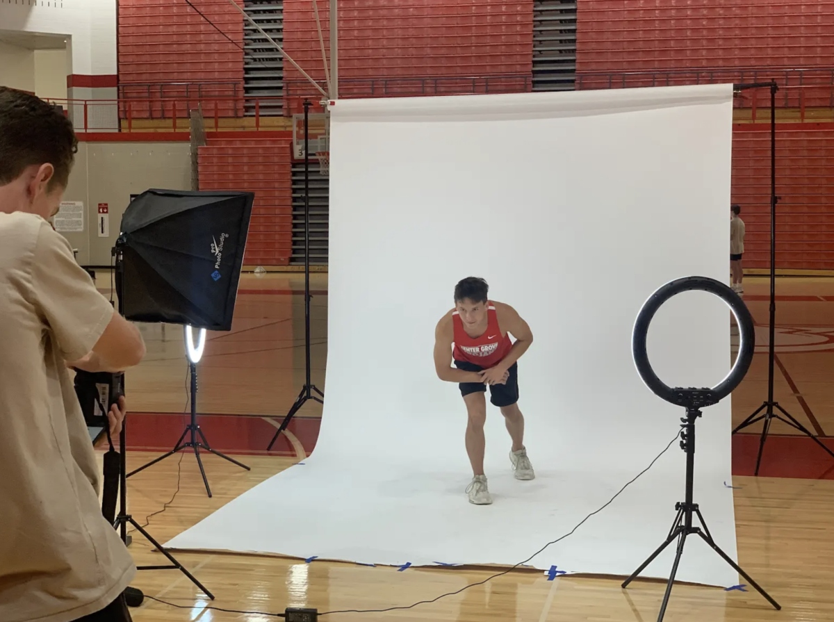 Junior Elliott Fisher poses as if a race were starting at media day. This event marked the first year that junior varsity athletes were asked to attend media day. “I think featuring JV can be beneficial so then JV meets can get more coverage,” Fisher said. “I liked how media day was a fun way to showcase our runners in preparation for the season.” 