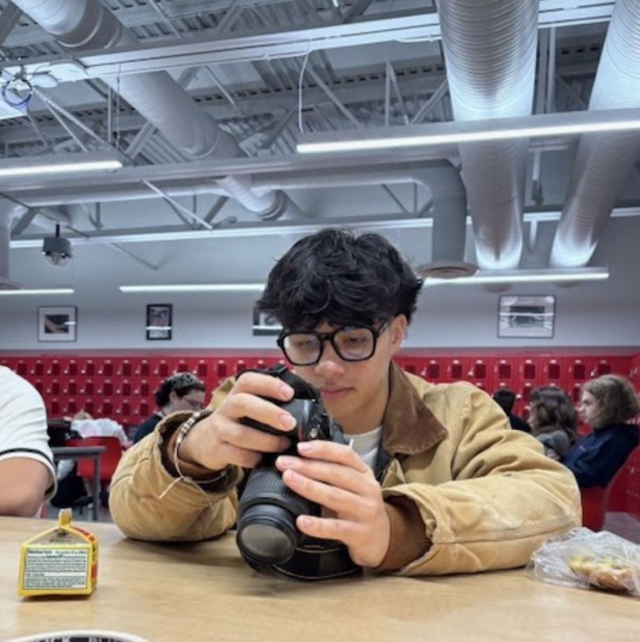 Senior Matthew Richardson, a second year photography student, reviews a carousel of pictures lodged within his cameras sd card. The class was  printing an 11x14 print of a photo students had taken over the summer, something Richardson had never done before. “I love photography because it gives me a chance to do something creative in a school environment," Richardson said.  “I’m excited; it’s the largest size print I’ve ever done.”