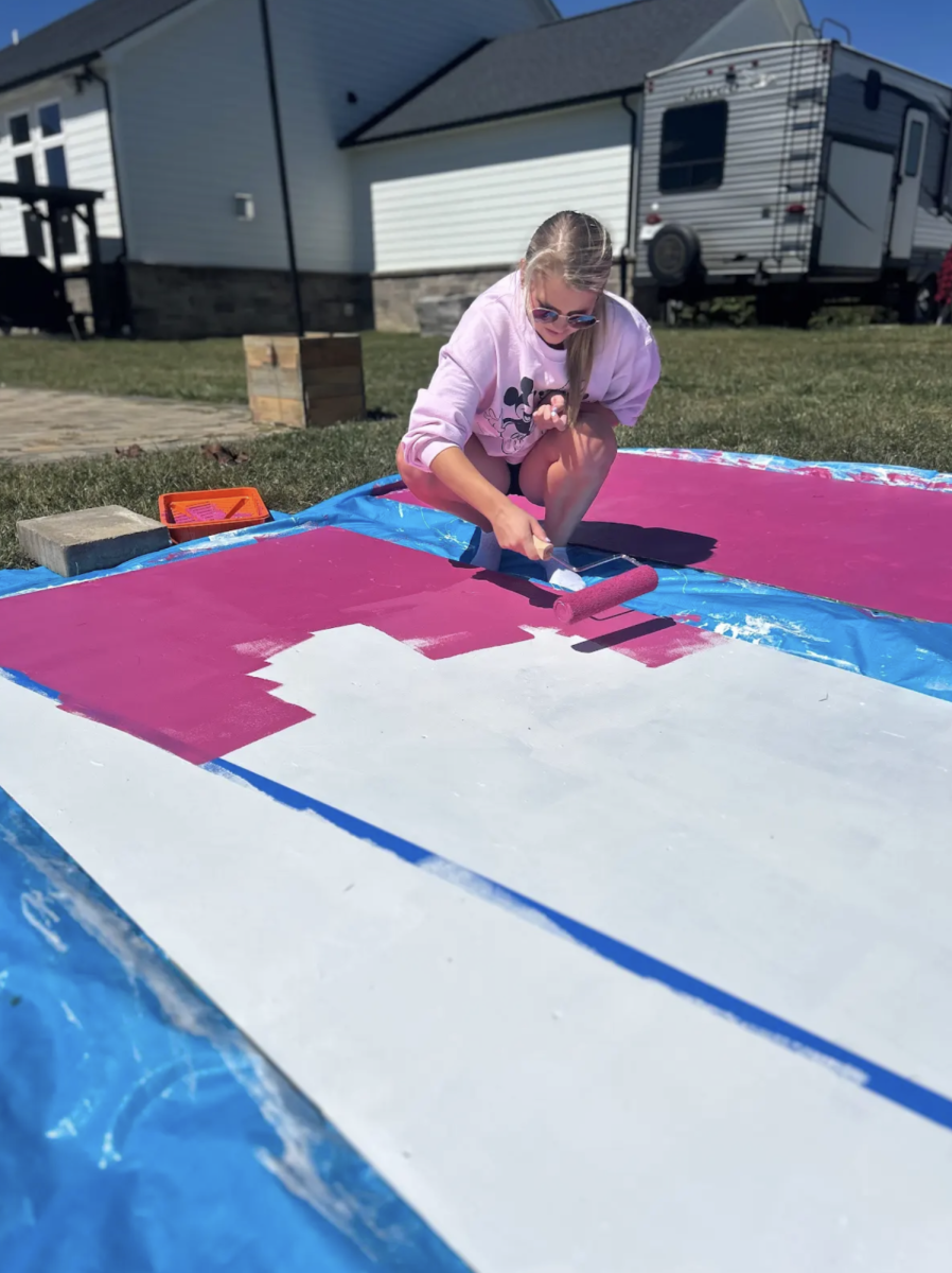 Preparing for the Homecoming parade, Student Council Senior Vice President Addi Siner paints the backdrop for the senior float. Homecoming is one of the big events Student Council plans, with each class of students taking charge of designing and building their floats. “The float building days are so important because they allow us to build our homecoming floats in a timely manner and make sure we are contributing,” Siner said.