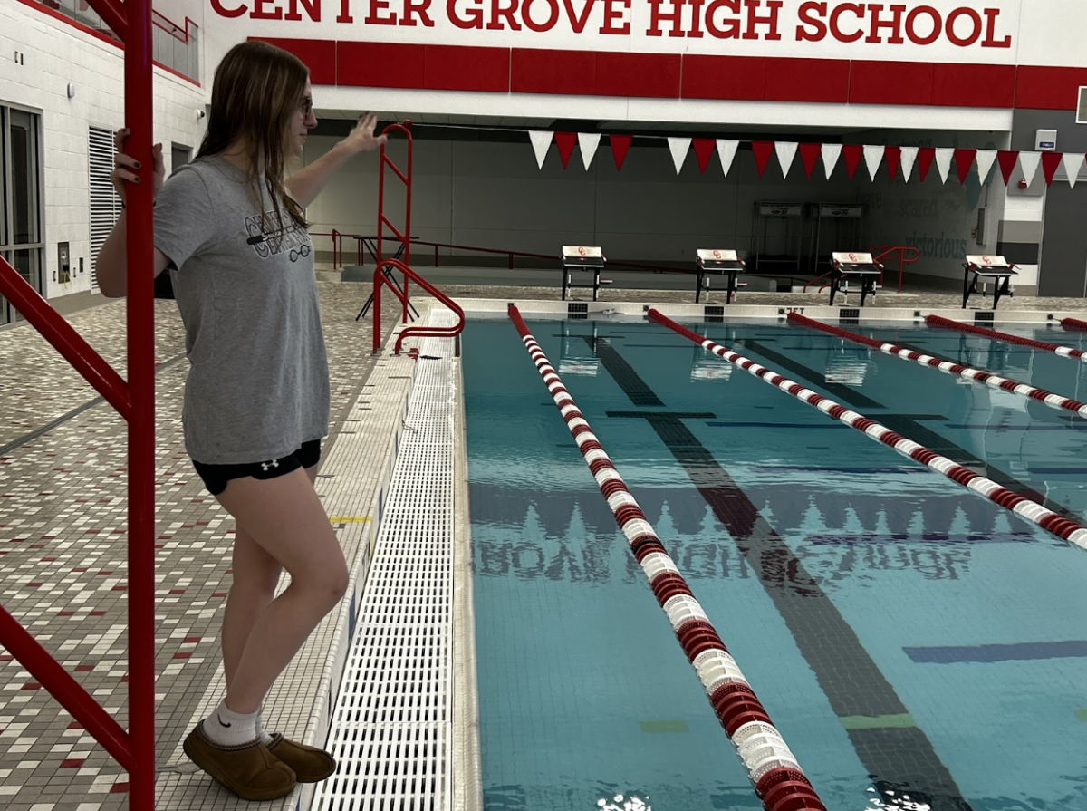 Junior Keeley Shields stands on the pool deck of the natatorium after practice to coach for Center Grove Aquatic Club
