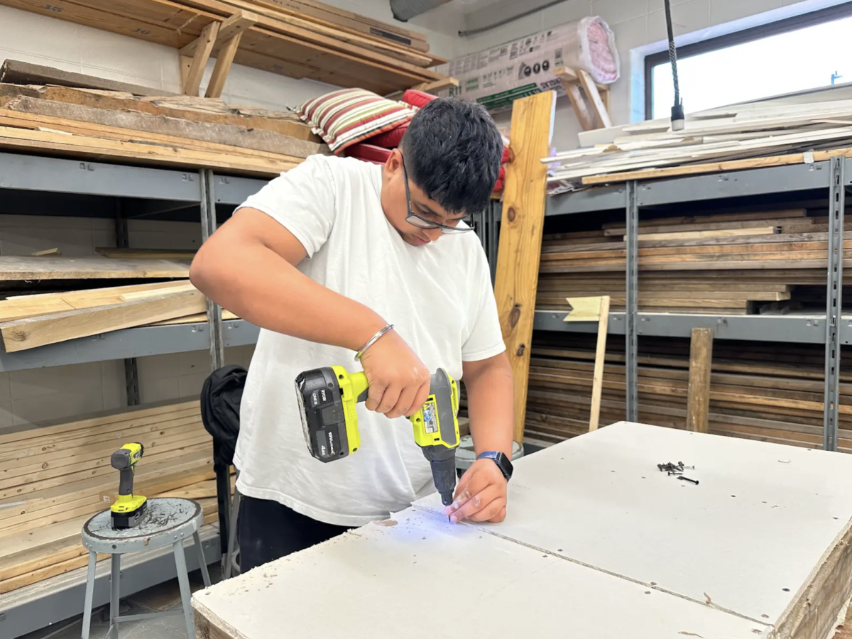 Sophomore Jasnoor Bains drills into his dry-wall project. The project was a part of the curriculum in his construction class. “One of the main reasons I chose second-year construction is because I really enjoy the freedom Mr. Werner gives us," Bains said. "It lets me be creative and make projects my own, without limits.”