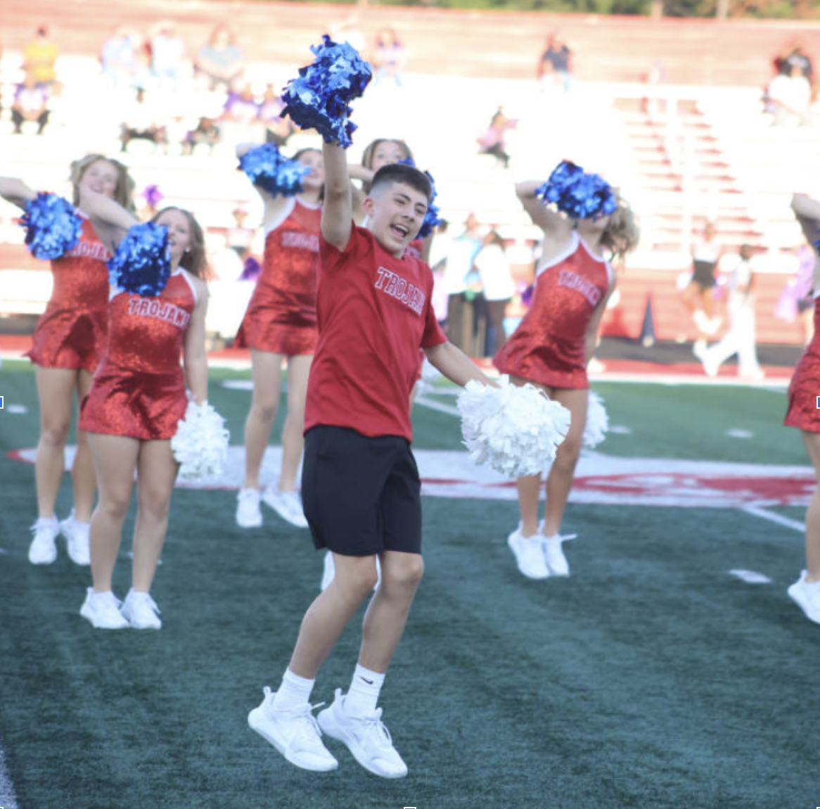 Freshman Kai Gonzalez-Ellett performs with the other dancers at a football game.