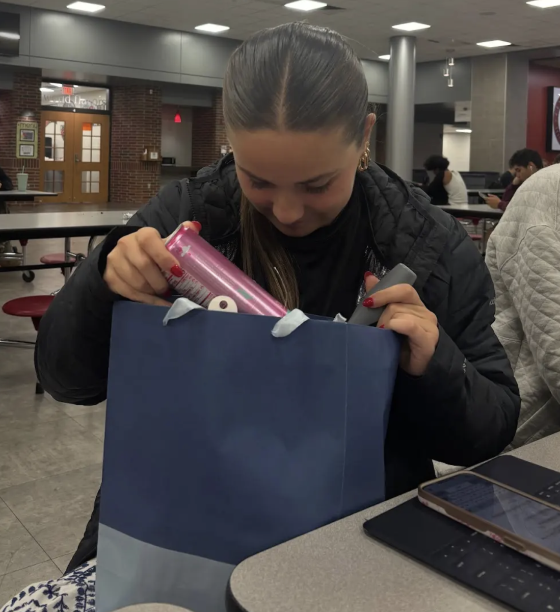 Opening her surprise gift in class, senior Ava Margiotti tries to figure out who her secret buddy is. Every year, during sectionals week, the girl’s soccer team has a spirit week that involves secret buddies. The players put gifts in each other’s classes all week in hopes of staying unknown. As the week builds up, they reveal themselves after the sectional game on Saturday. “I really like doing secret buddies because I feel like it just brings the team together and is a fun thing we have always done to start the postseason off on a good note and keep it upbeat,” Margiotti said. 