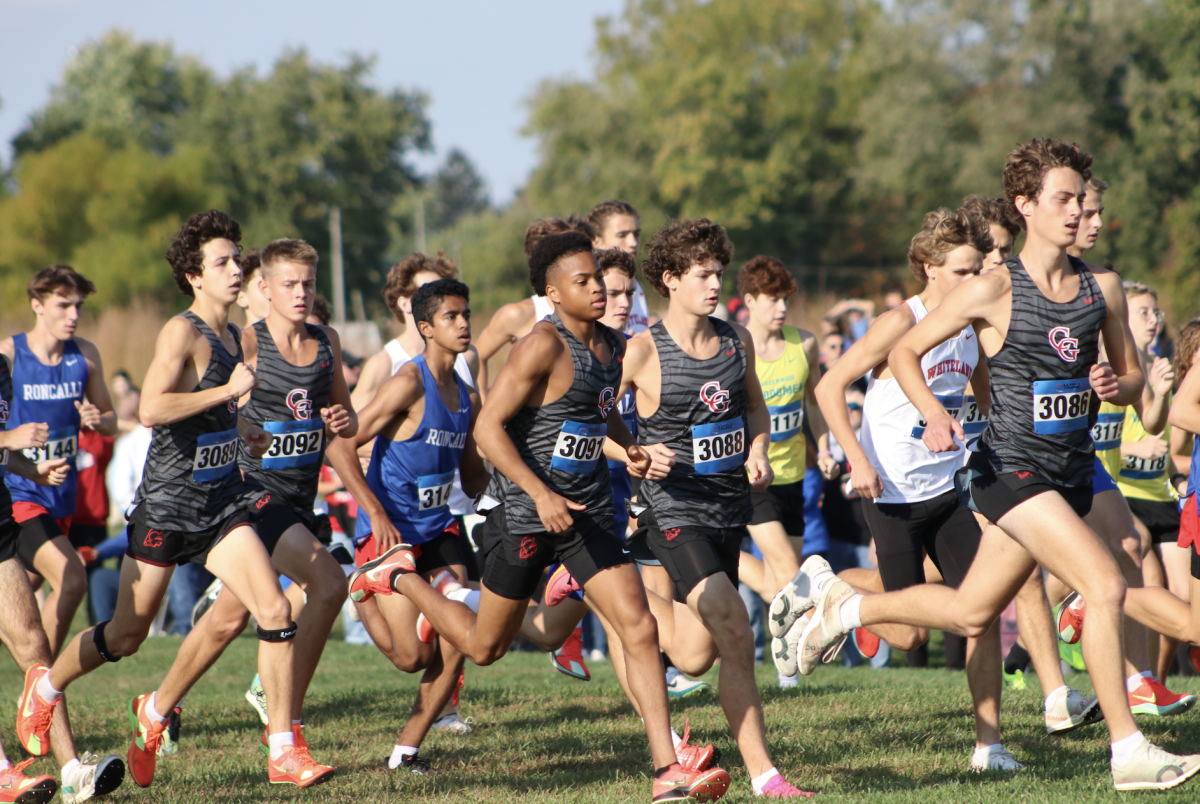 The boys Cross Country team runs the opening straight in Shelbyville to begin their Sectional race.