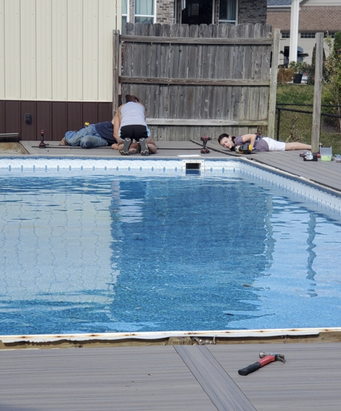 Freshman Kylie Craven helps her father clean out a plumbing pool during a weekend job.

