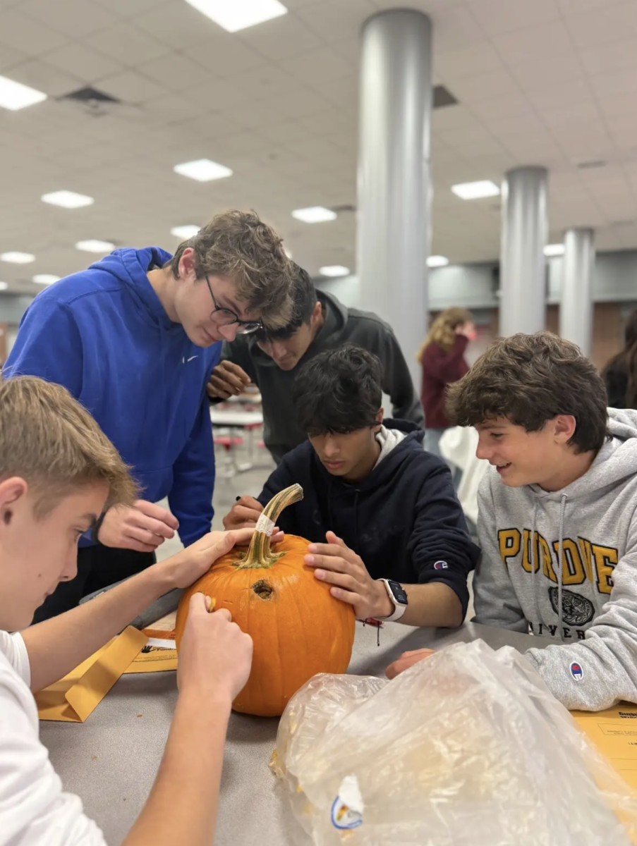 At the HOSA Pumpkin Pathology activity, Juniors Daniel LaRocca, Austin Petkovich, Kanish Munjaal, Chinmay Karyekar and J Stout carve their pumpkin in an attempt to make it look like it has vitiligo. “Vitiligo can cause a thyroid disorder, eye problems and discoloration of the skin," Karyekar said. "That's what we were trying to describe on the pumpkin. We did this by making his eyes physically distorted and cutting off patches of the pumpkin skin all around so it is whiter than the deeper shade of orange it usually has.” 