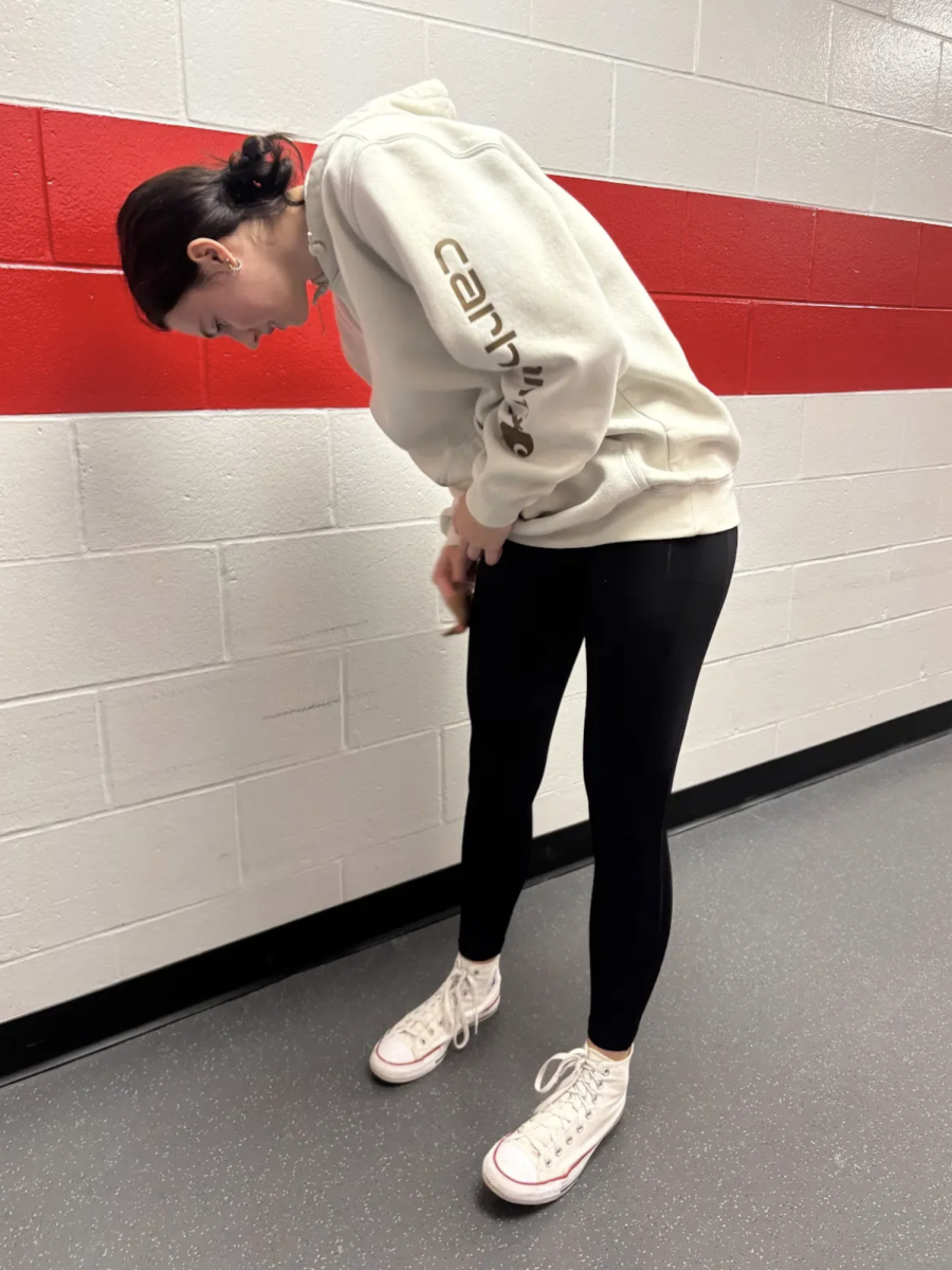 With a wet paper towel in hand, Senior Madi Bussard wipes clay off of her pants. Students in Mr. Fry's Ceramics class have recently begun using a clay wheel in class, which has left many with dust-stained pants. “We are throwing on the wheel right now,” Bussard said. “It is fun, but also annoying because clay gets everywhere.”