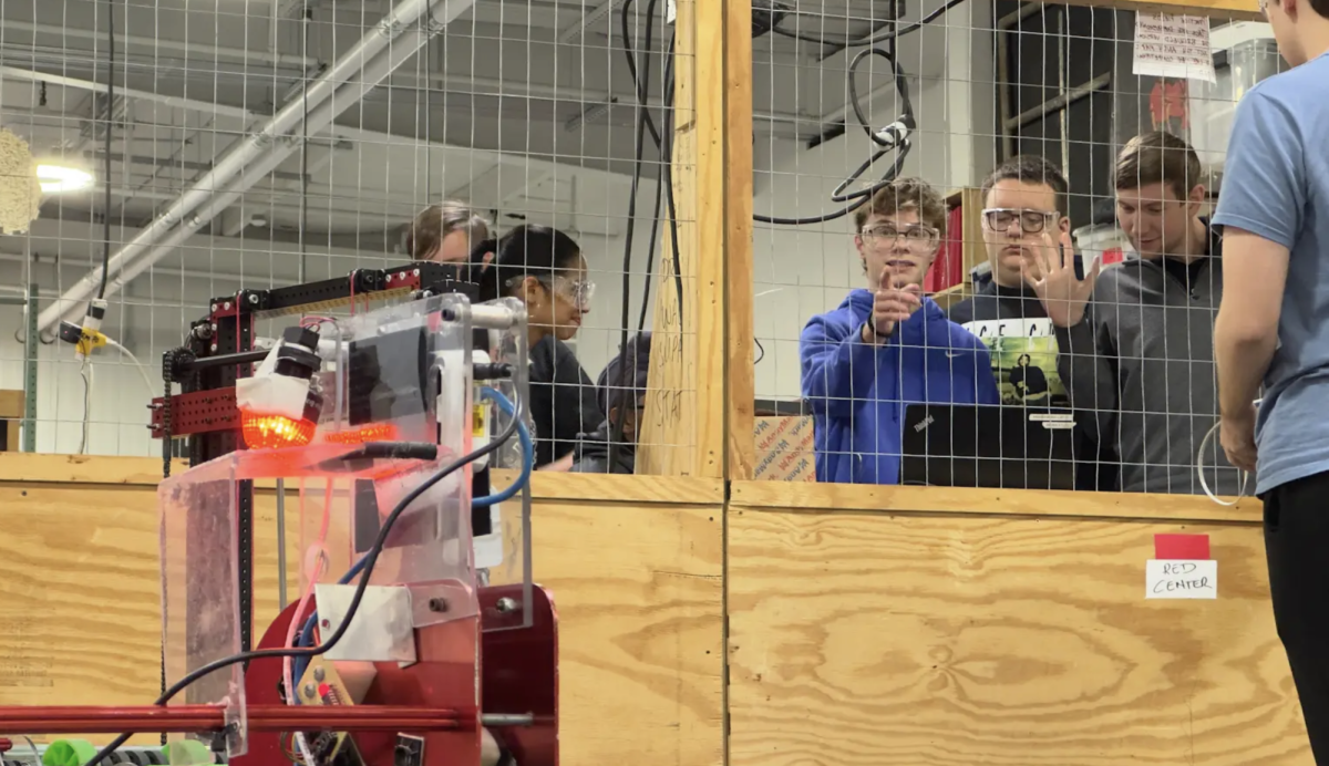 Junior Austin Petkovich attempts to fix a malfunctioning robot for Robotics. "We're trying to get one of our robots working for an upcoming demo that we have," Petkovich said. "This robot is going to be used to launch pumpkins at Clark Pleasant library. It's a robot that we built in 2014, and it just has good dimensions and good geometry to launch pumpkins in a cool way.”