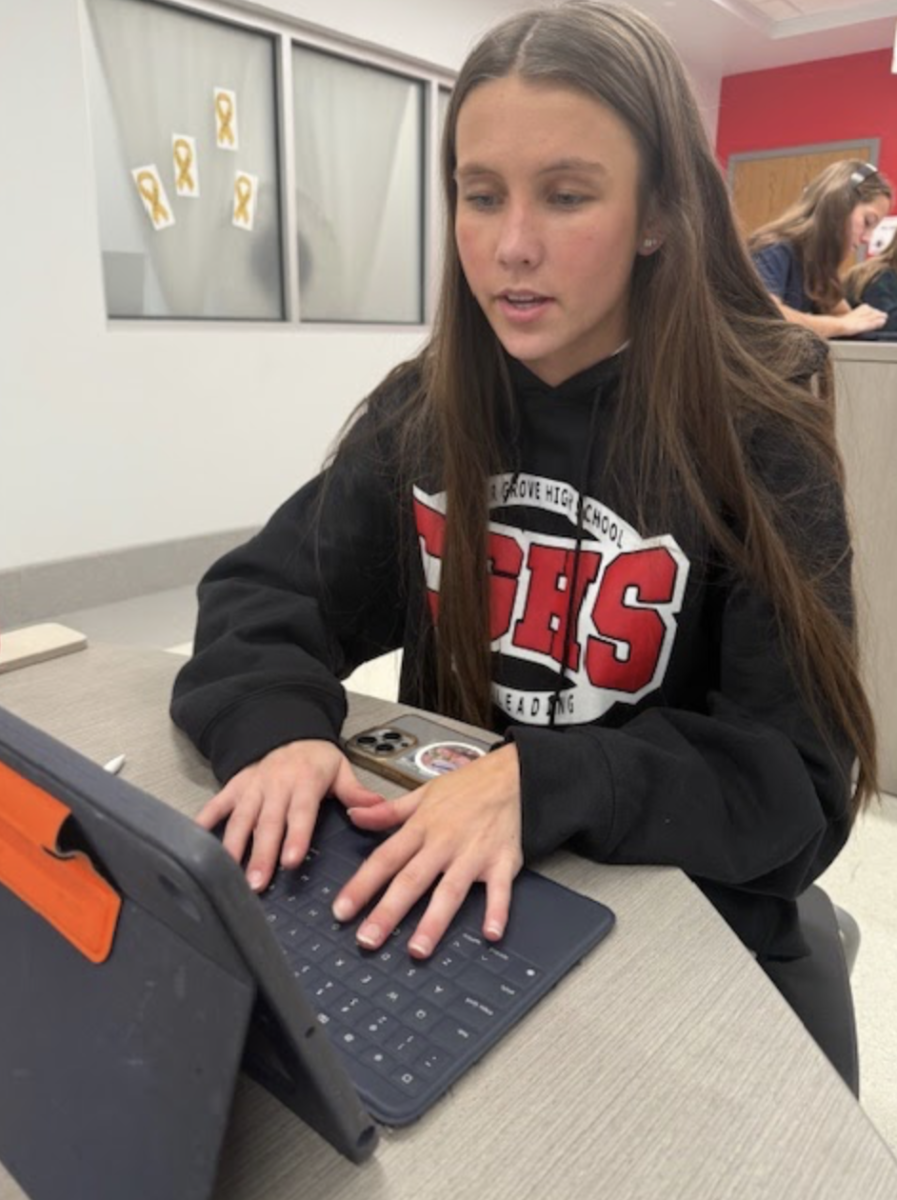 "Senior Selia Peters writes a CTA in her sociology class. The class watched the movie “Masterminds” in order to understand how deviance is pressured by society. “My topic was control theory which explains how relationships and bonds correlate to deviance,” Peters said. “The movie helped me focus on why groups of people react the way they do, which results in deviant behaviors.”