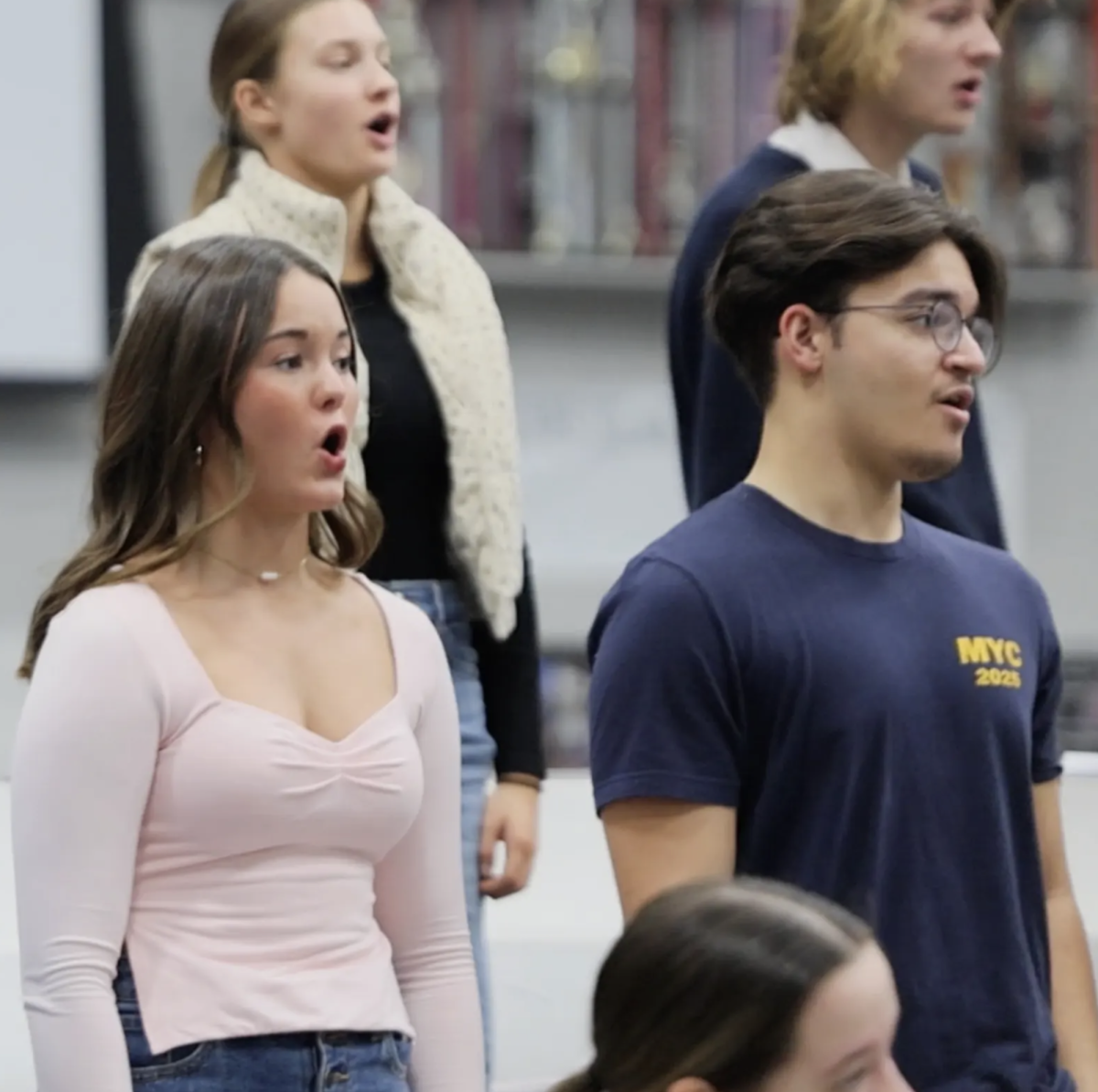 In preparation for their performance with the Indianapolis Symphony Orchestra, CG Singers Katelyn Graham and Alex Acosta practice during class. The group sang parts of the soundtrack to the Christmas movie "Home Alone" alongside the orchestra. “I’m really excited to work with such talented professionals and learn from their experience,” Graham said. “Singing with the Symphony Orchestra alongside my choir is an incredible opportunity, and I can’t wait for the experience ahead.”